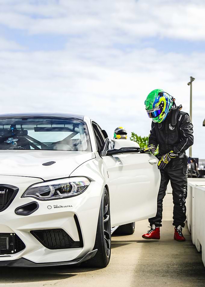 Race Car Driver and White Sports Car