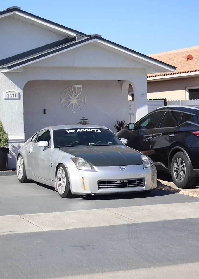 Silver Nissan 350Z parked outside house