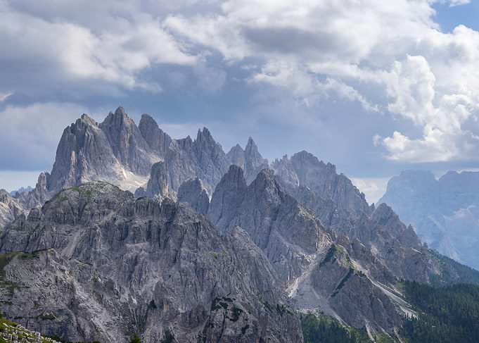 Majestic Mountain Range Under Cloudy Sky