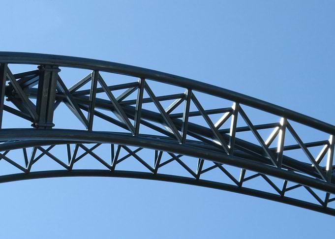 Rollercoaster track against blue sky