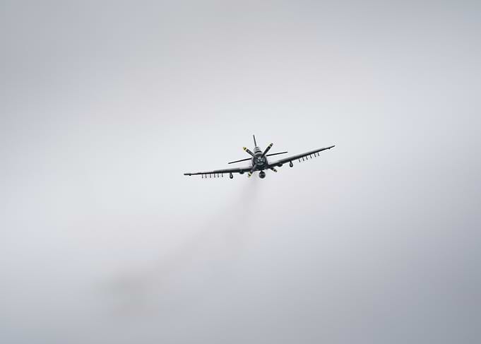 Vintage Airplane Flying in Cloudy Sky