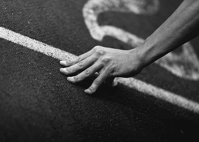 Hand on Running Track in Black and White