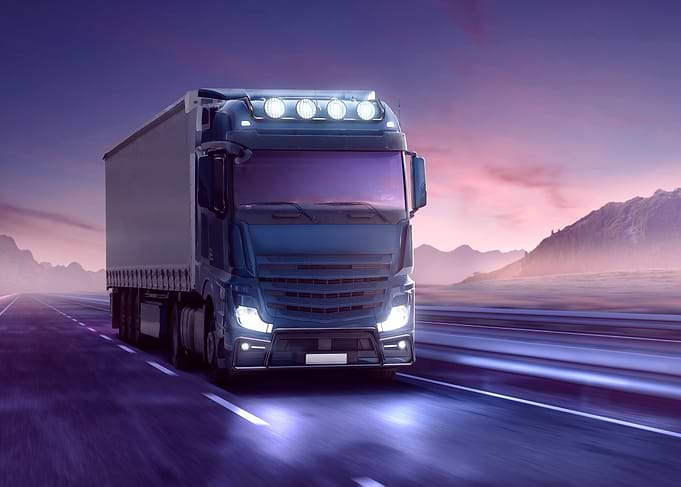 Blue Semi-Truck on Highway at Dusk