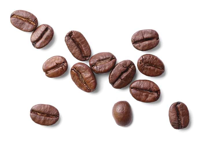 Scattered Coffee Beans on White Background