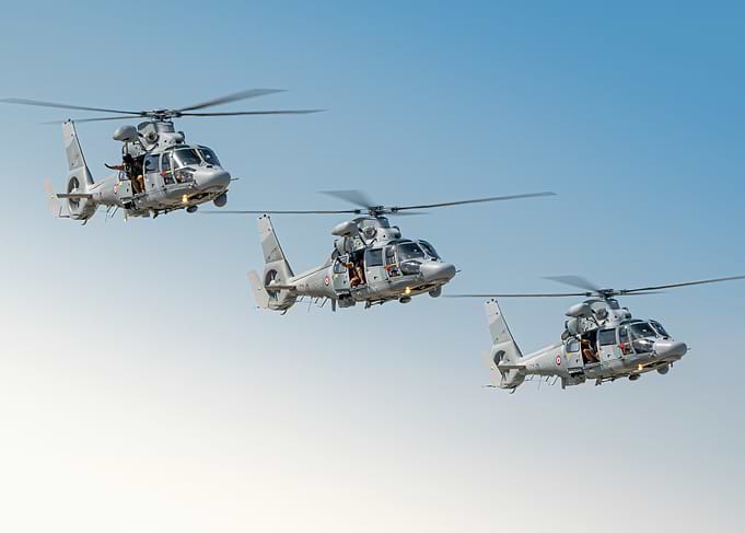 Three Panther Military Helicopters in Flight Formation