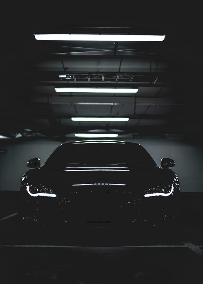 Sleek Black Car in Dark Garage