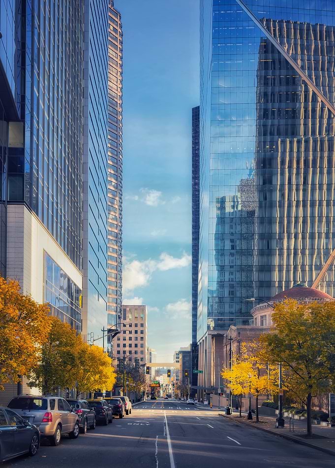 Downtown street with skyscrapers and autumn trees
