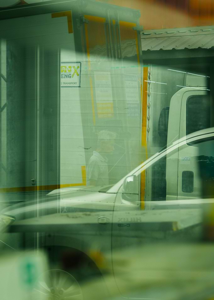 Reflections of a Truck, Car and a man