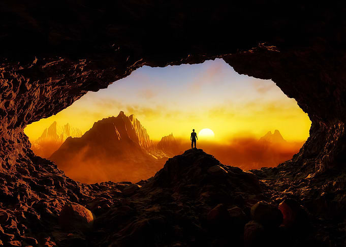 Man in Cave at Sunset