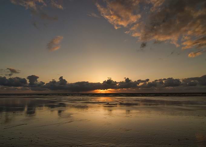 Sunset Reflection on Wet Beach Sand