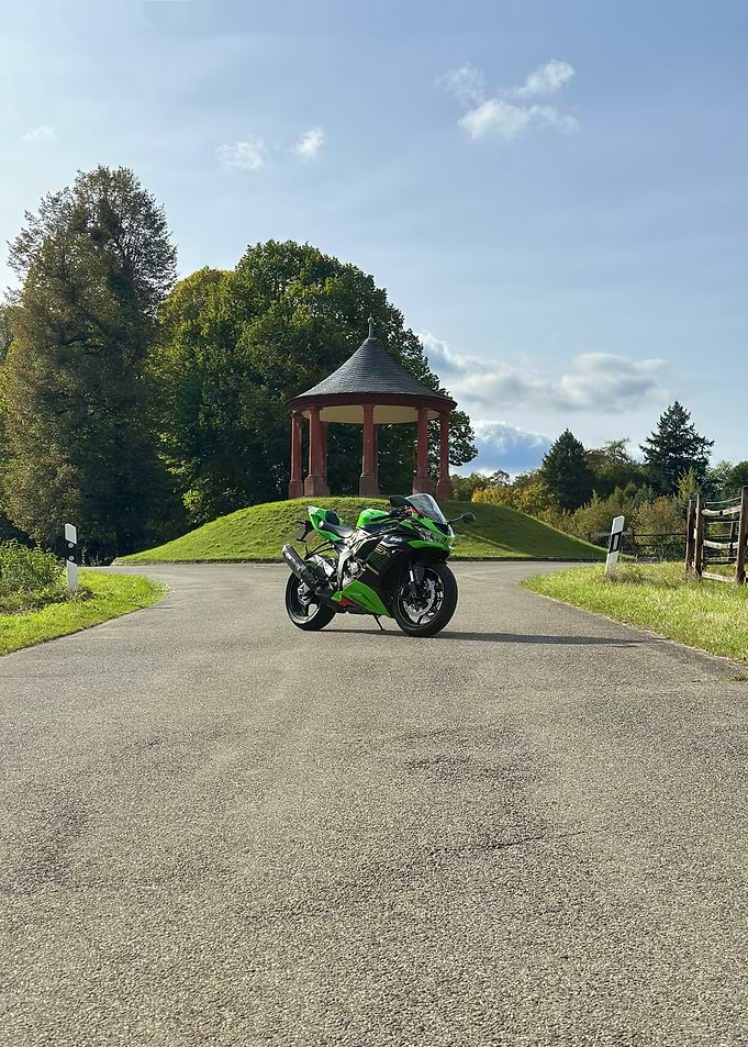 Green and Black Motorcycle on Road