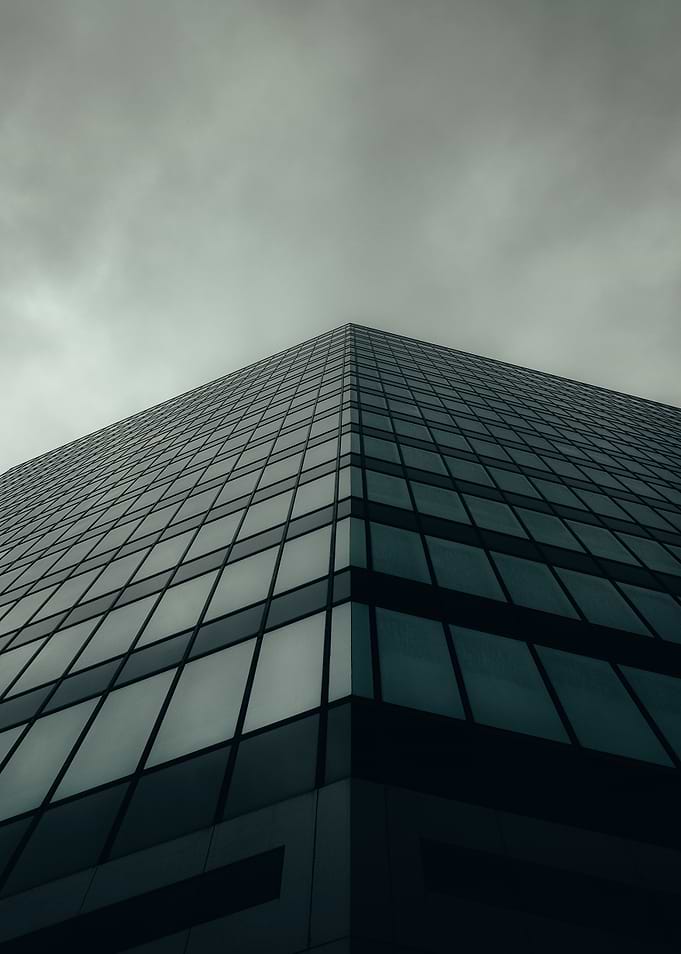 Modern Glass Building Under Cloudy Sky