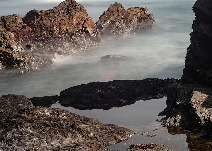 Rocky Coastline with Misty Water