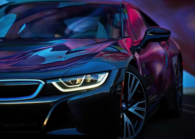Sleek Black Car with Colorful Reflections