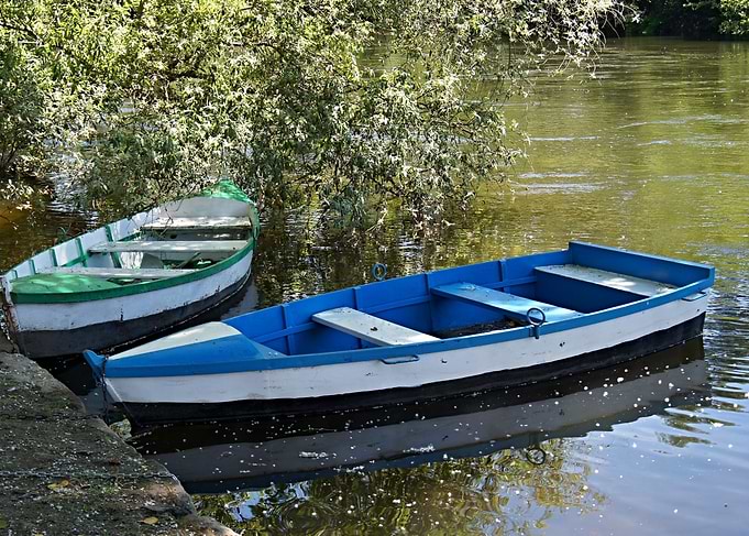 Two wooden boats on calm water