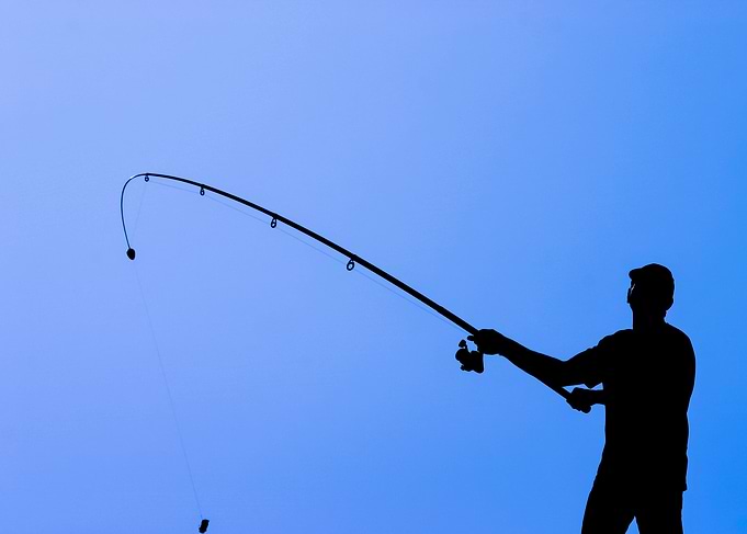 Silhouette of Fisherman Casting Rod
