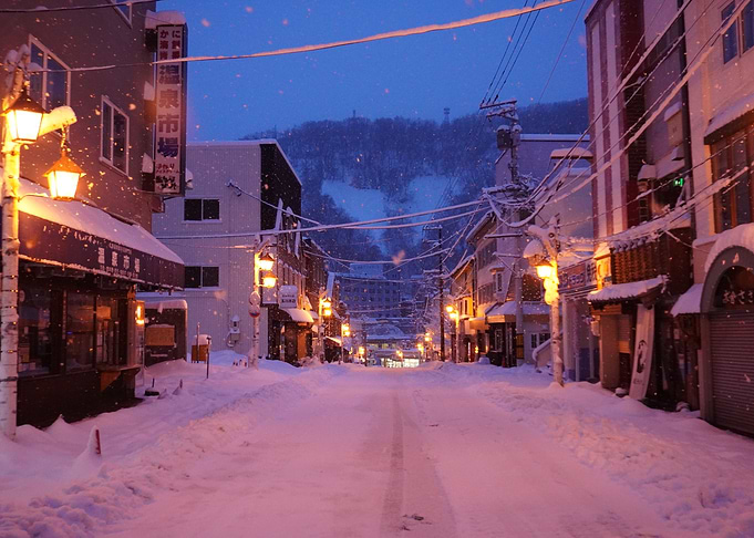 Snowy street at dusk in Japan