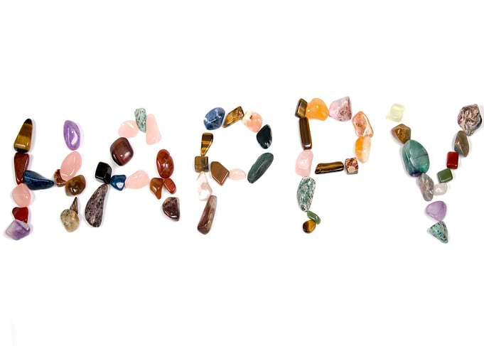 Happy word made of colorful stones
