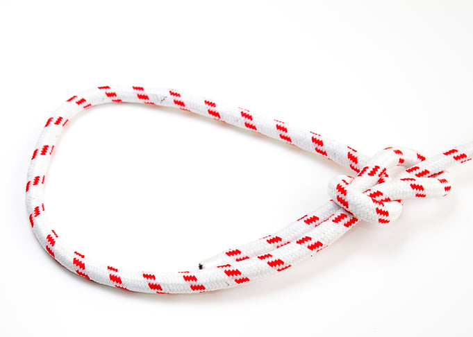 White rope with red pattern knBowline Knot on white background one of the most used loop knots