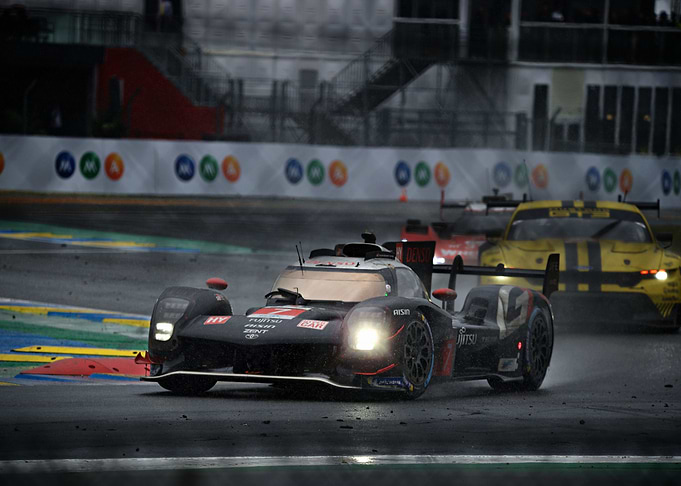 Racing cars on a wet track