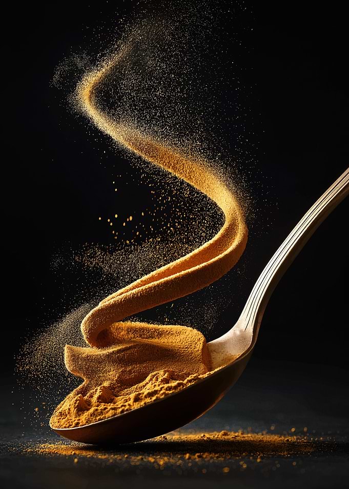 Golden Turmeric Powder on Spoon