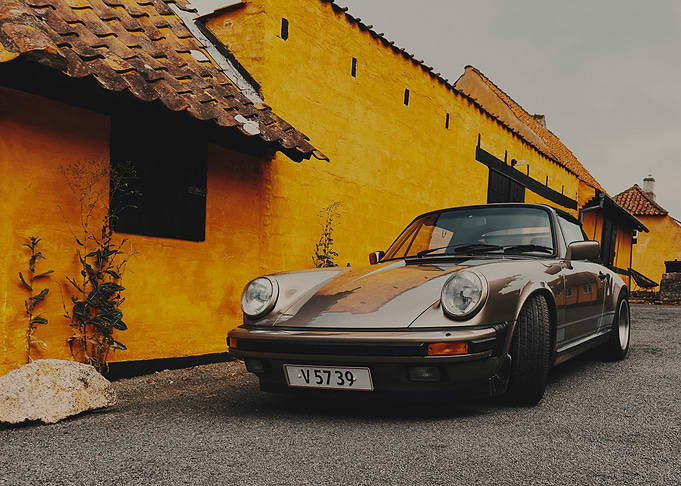 Classic Car by Yellow Building