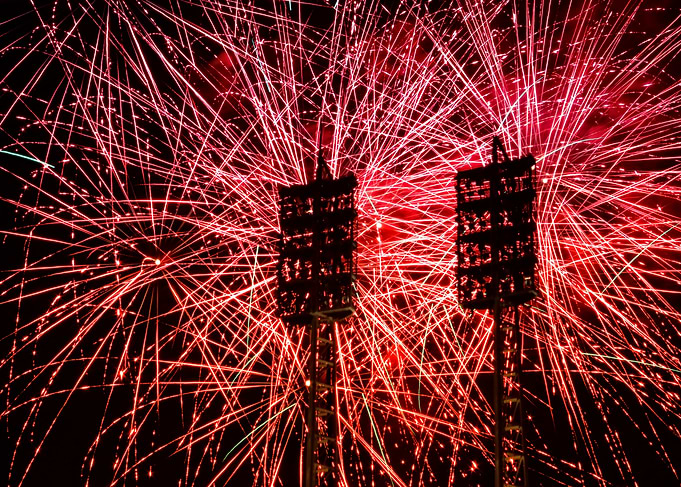 Red Fireworks Display with Stadium Lights