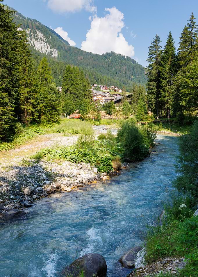 Mountain Stream Avisio and Village Landscape