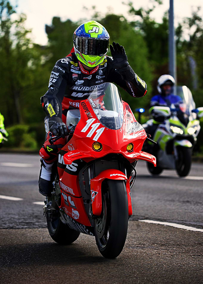 Motorcycle Racer Waving on Red Bike