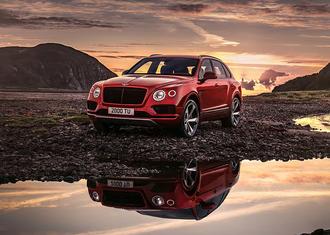 Red Bentley SUV Reflection at Sunset