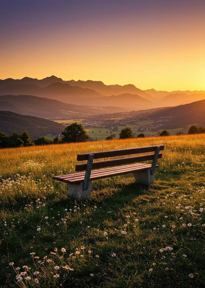Bench overlooking mountain landscape at sunset
