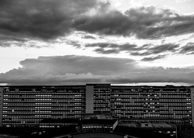 Black and White Building Under Cloudy Sky