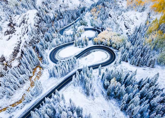 Winter Road Through Snowy Forest