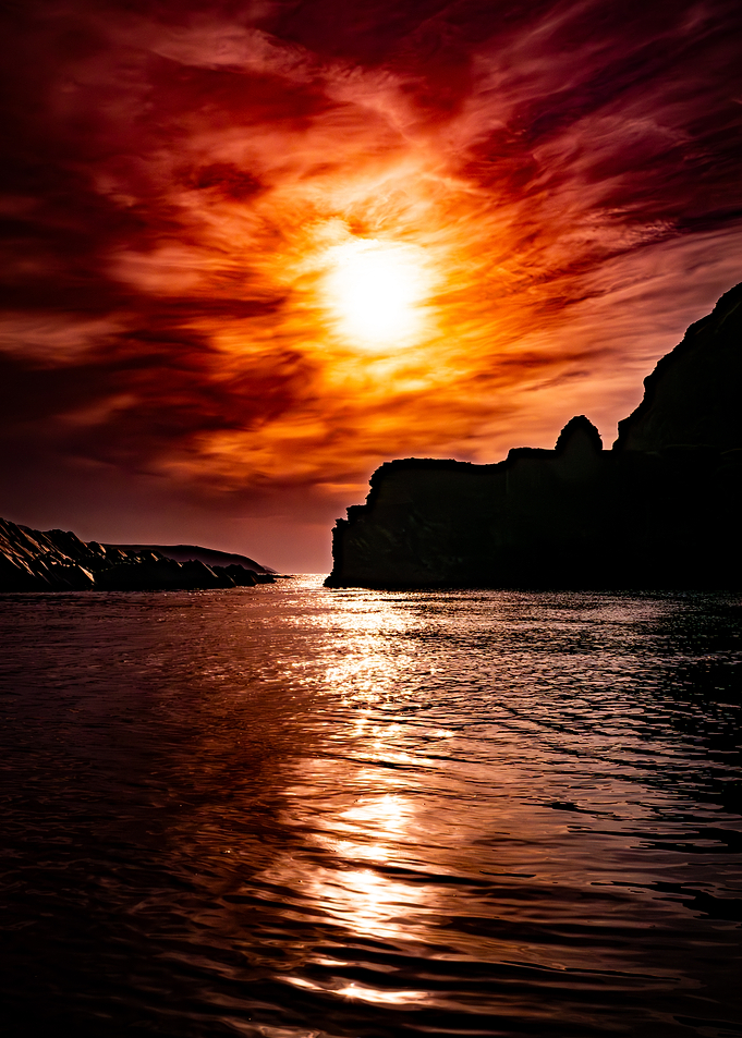 Fiery Sunset Over Ocean Cliffs