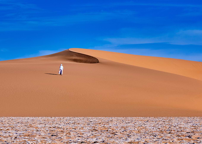 Desert Wanderer Under Blue Sky