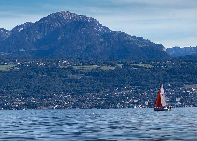 Sailboat on Leman Lake with Mountain Backdrop