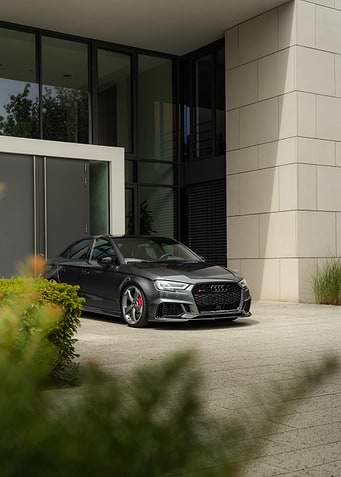 Gray Audi RS3 parked outside building