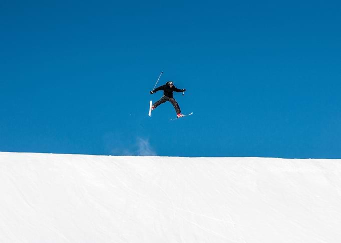 Skier Jumping Against Blue Sky