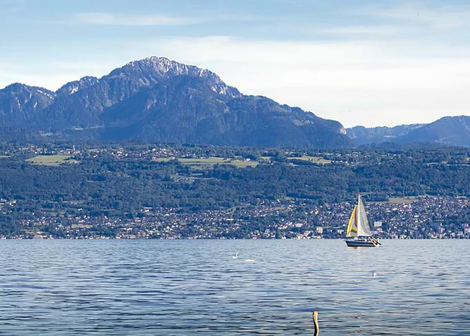 Sailboat on Leman Lake with Mountain Backdrop