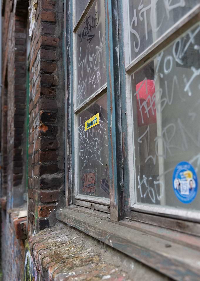 Graffiti-covered window on brick building