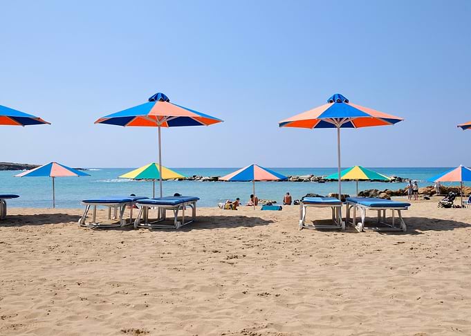 Beach Umbrellas and Loungers on Sandy Shore