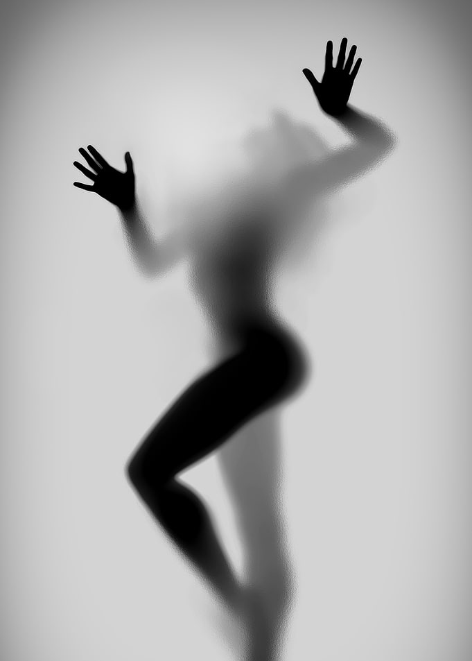 Silhouette of a Woman Behind Glass