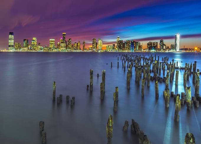 cityscape at dusk with wooden pilings