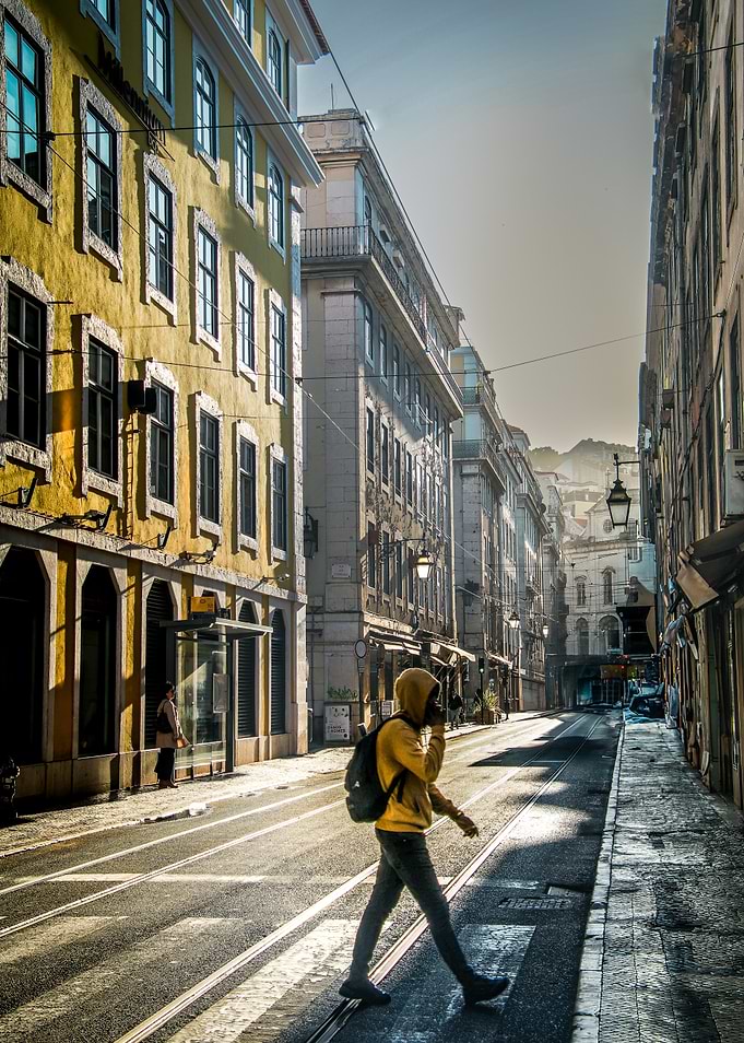 Person Crossing Street in Lisbon, Portugal