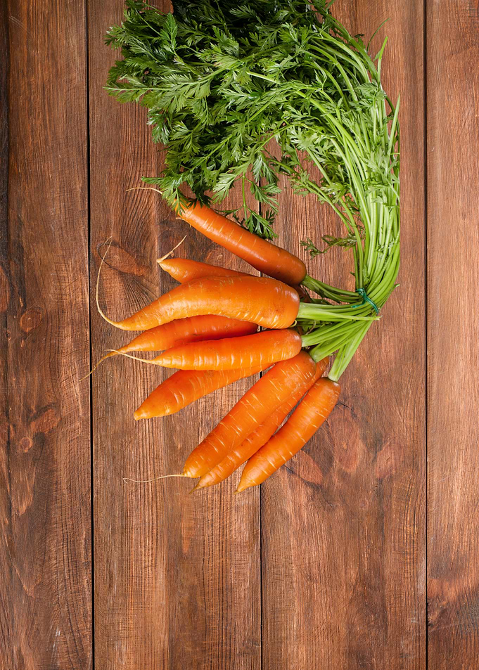 Fresh Carrots on Wooden Surface