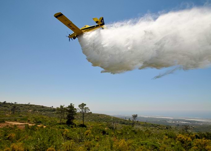 Crop Duster Plane Spraying Over Landscape