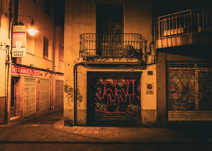 Night street with graffiti and shops