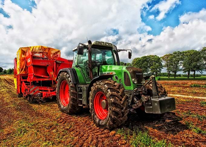 Green Tractor with Red Harvester