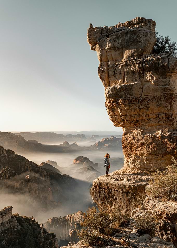 Cliffside View with Person and Fog