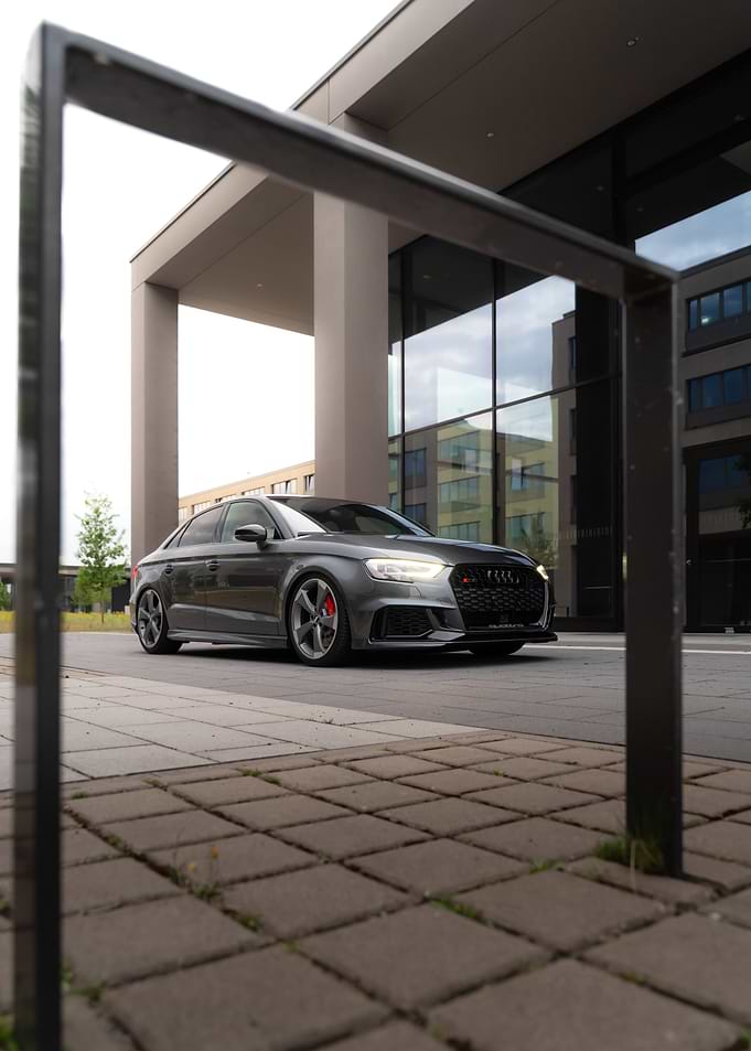 Gray Audi RS3 parked near building
